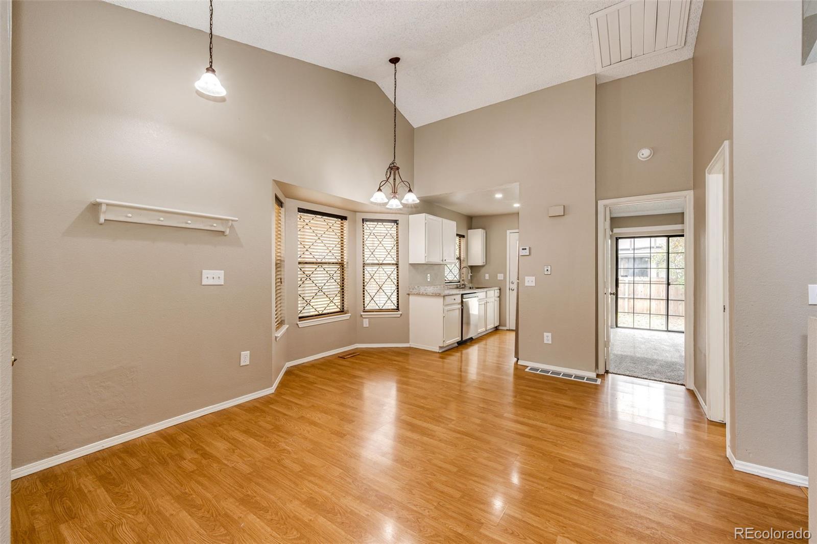 18538 East Whitaker Circle, Unit E Aurora, CO 80015 - Photo 10 of 31 a view of an empty room with window and wooden floor