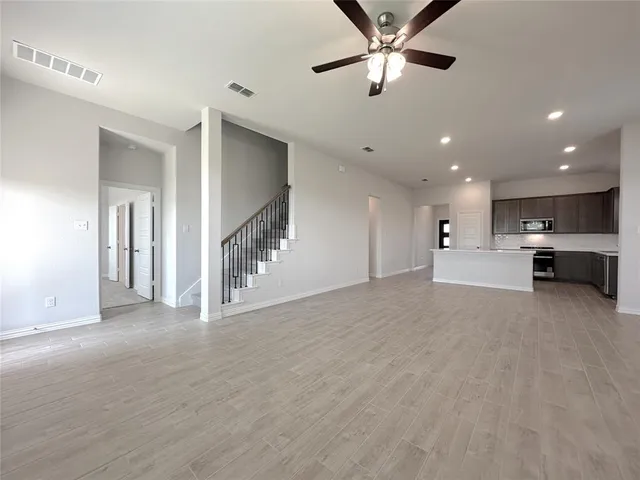 a view of an empty room with a ceiling fan