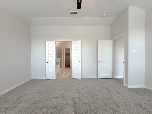 an empty room with fan and entrance
