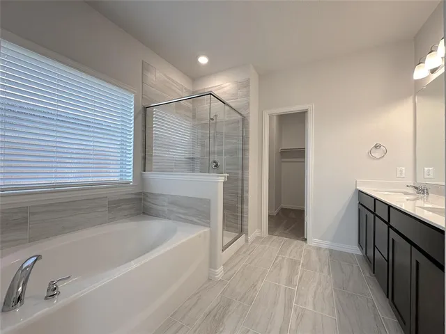 a spacious bathroom with a bathtub and a sink