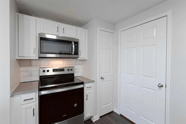 a kitchen with a stove microwave and sink