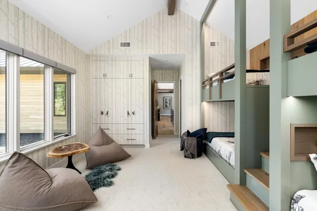 a bedroom with furniture and a large window