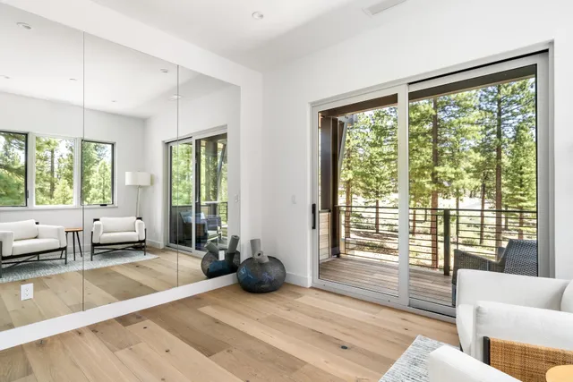 a living room with furniture and large windows