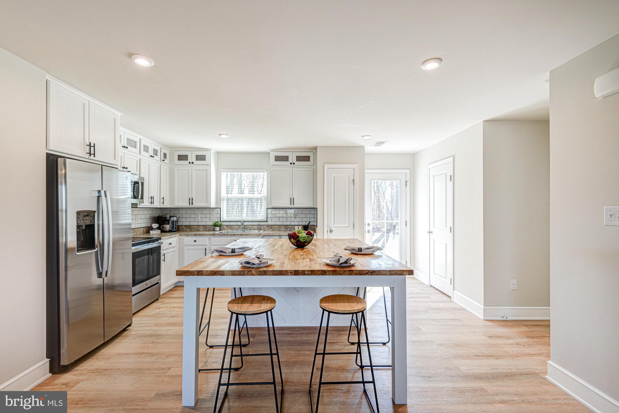 293 Sedimentary Rock Road Dover, DE 19904 - Photo 20 of 36 a kitchen with kitchen island granite countertop a sink and refrigerator