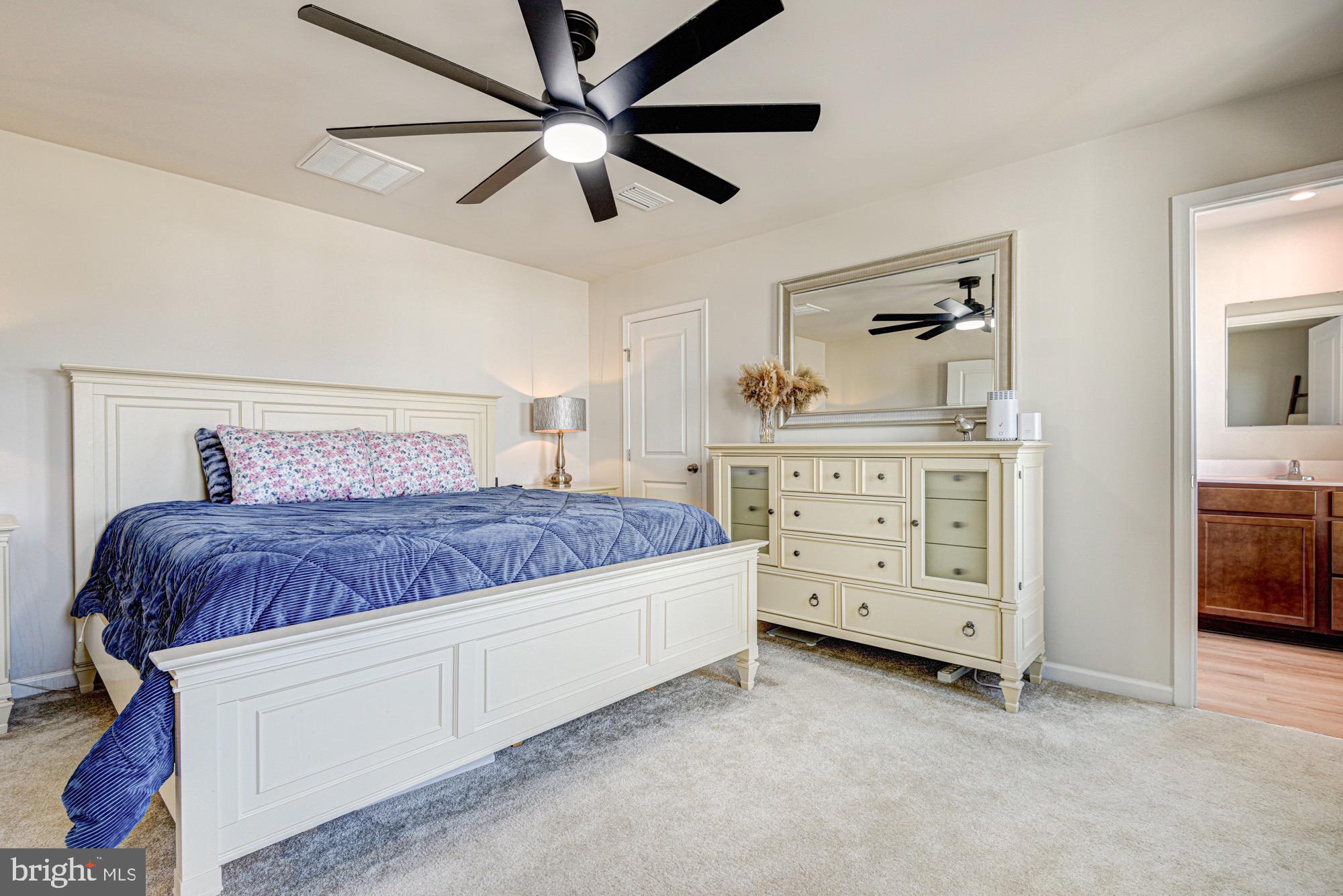 293 Sedimentary Rock Road Dover, DE 19904 - Photo 24 of 36 a spacious bedroom with a bed and a cabinets