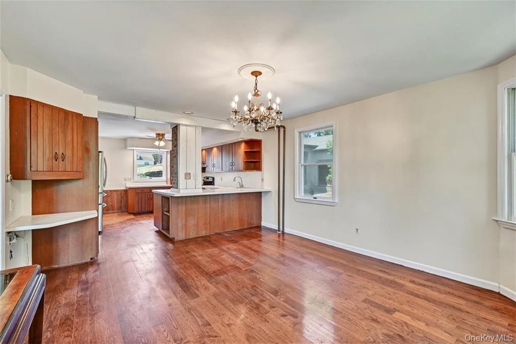 7 Schunnemunk Road Highland Mills, NY 10930 - Photo 5 of 27 a living room with kitchen island furniture and a chandelier