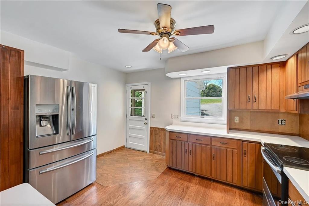 7 Schunnemunk Road Highland Mills, NY 10930 - Photo 7 of 27 a kitchen with stainless steel appliances and wooden cabinets