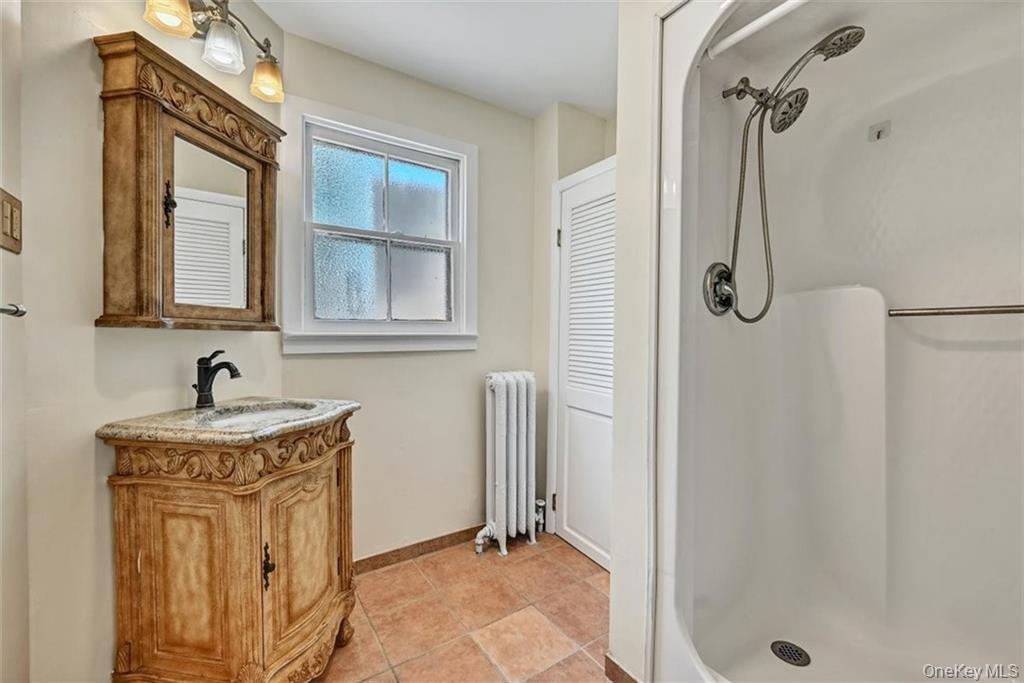 7 Schunnemunk Road Highland Mills, NY 10930 - Photo 10 of 27 a bathroom with a granite countertop shower a mirror and a sink