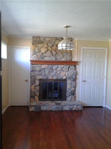 1746 West Grab Creek Road Dickson, TN 37055 - Photo 9 of 20 New Laminate Wood Flooring in Dining Room with Rock Fireplace & Kitchen. Notice a Closet is situated on each side of the Rock Fireplace for extra Storage