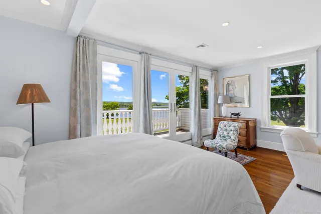 a bedroom with a large bed and a large window