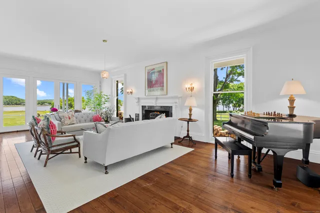 a living room with furniture fireplace and a table