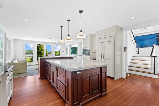 a kitchen with a stove and wooden floor