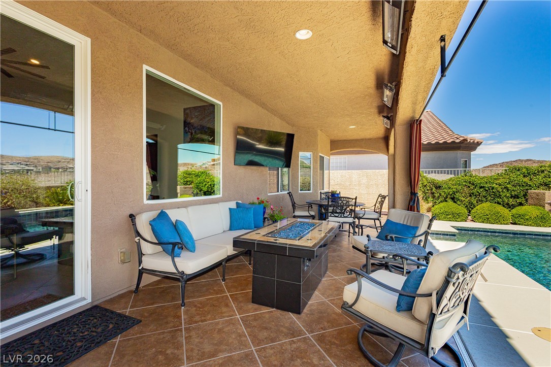 2256 Dogwood Ranch Avenue Henderson, NV 89052 - Photo 44 of 51 An inviting covered patio featuring an outdoor living area and sparkling swimming pool.