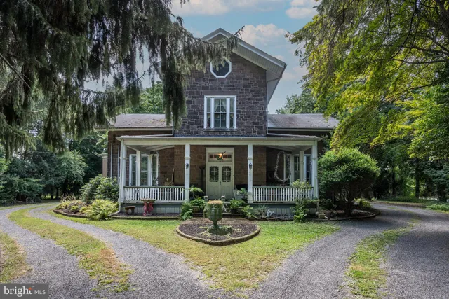 a front view of a house with a yard garage and outdoor seating