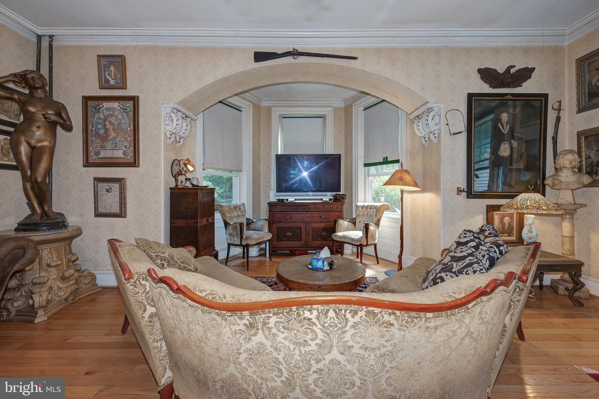 705 Woodlane Road Beverly, NJ 08010 - Photo 17 of 65 a living room with furniture a fireplace and potted plants