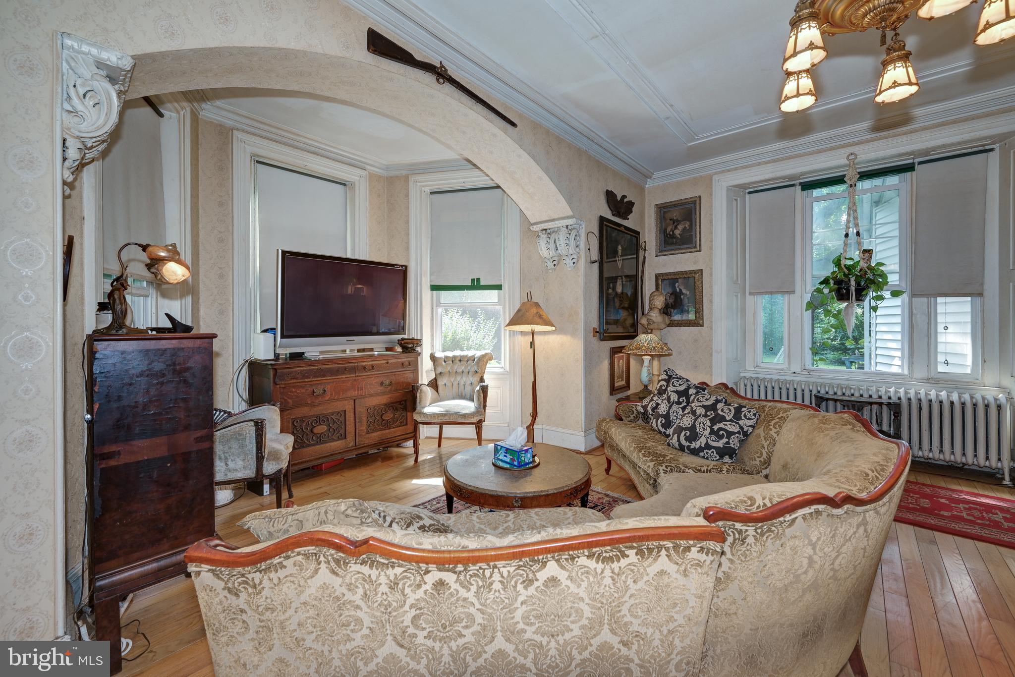 705 Woodlane Road Beverly, NJ 08010 - Photo 19 of 65 a living room with furniture and a flat screen tv