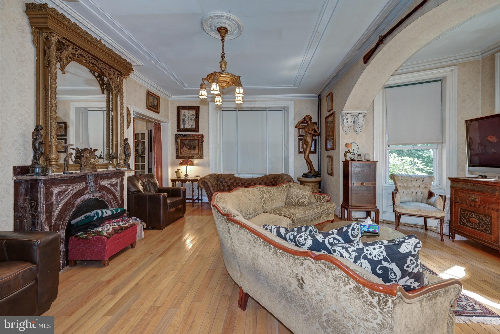 705 Woodlane Road Beverly, NJ 08010 - Photo 20 of 65 a living room with furniture windows and a flat screen tv