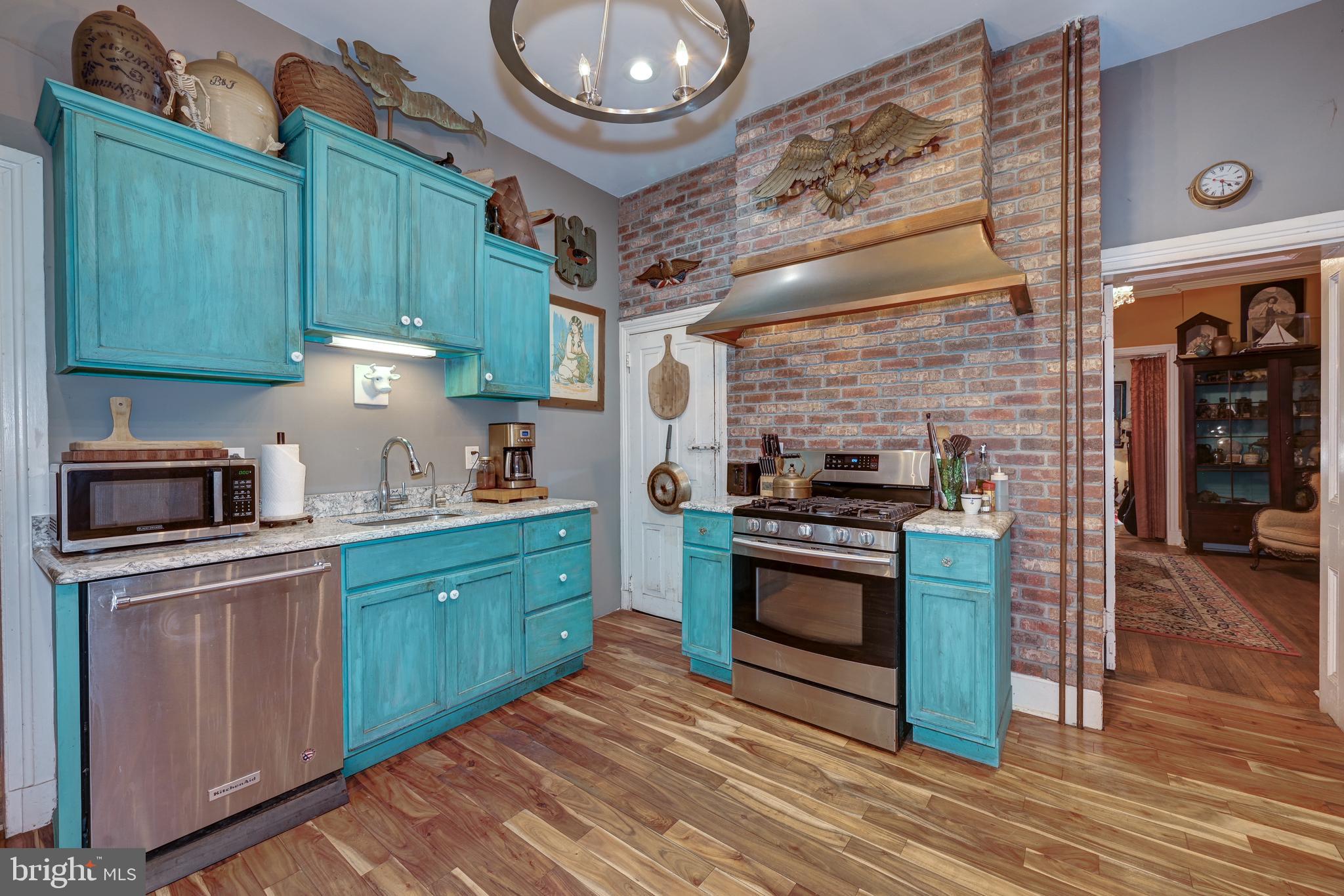 705 Woodlane Road Beverly, NJ 08010 - Photo 27 of 65 a kitchen with granite countertop a sink cabinets and stainless steel appliances