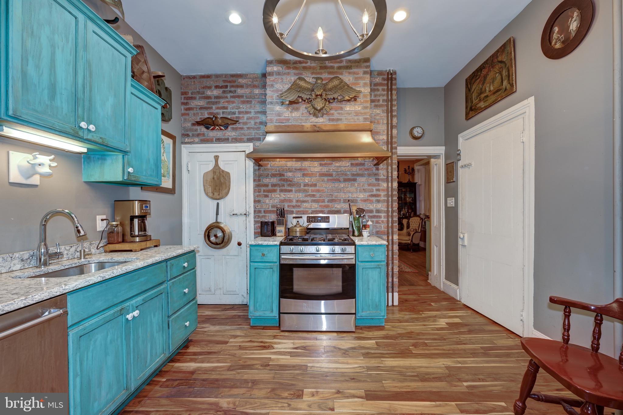 705 Woodlane Road Beverly, NJ 08010 - Photo 28 of 65 a kitchen with stainless steel appliances granite countertop a stove and a sink