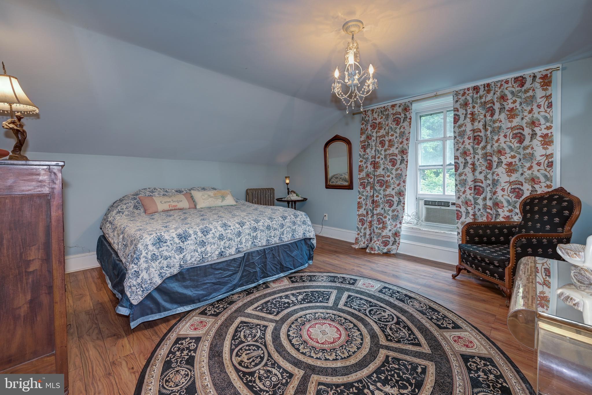 705 Woodlane Road Beverly, NJ 08010 - Photo 47 of 65 a bedroom with bed and a chandelier