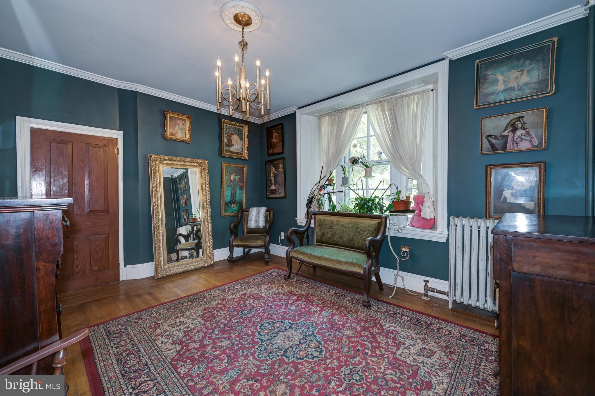705 Woodlane Road Beverly, NJ 08010 - Photo 48 of 65 a living room with furniture and a chandelier