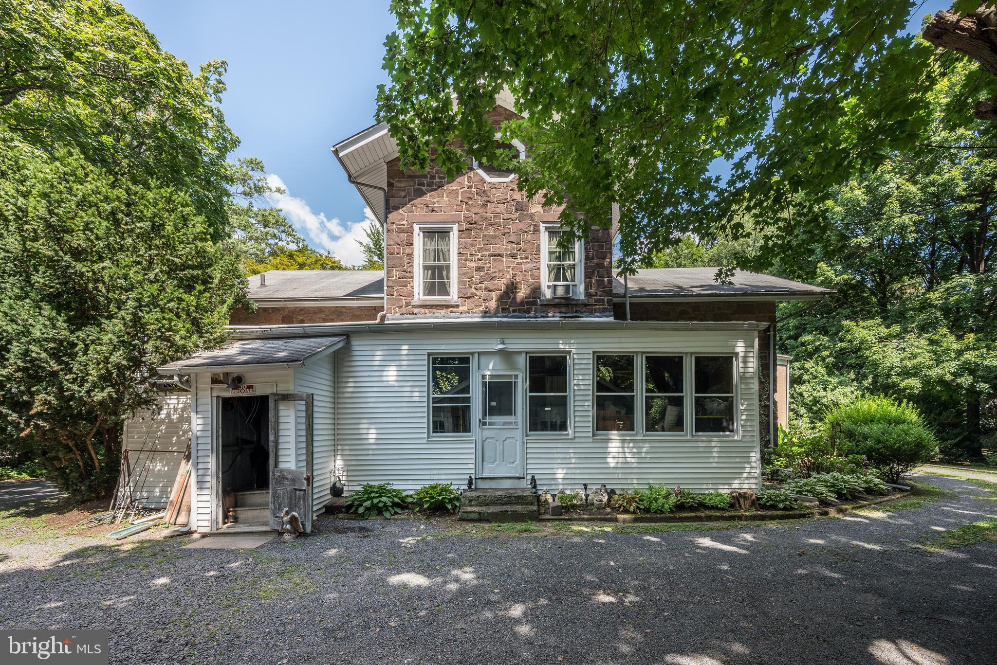 705 Woodlane Road Beverly, NJ 08010 - Photo 58 of 65 a view of a white house with large windows and a large tree