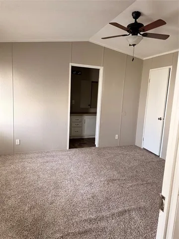 a view of a livingroom with a ceiling fan and window