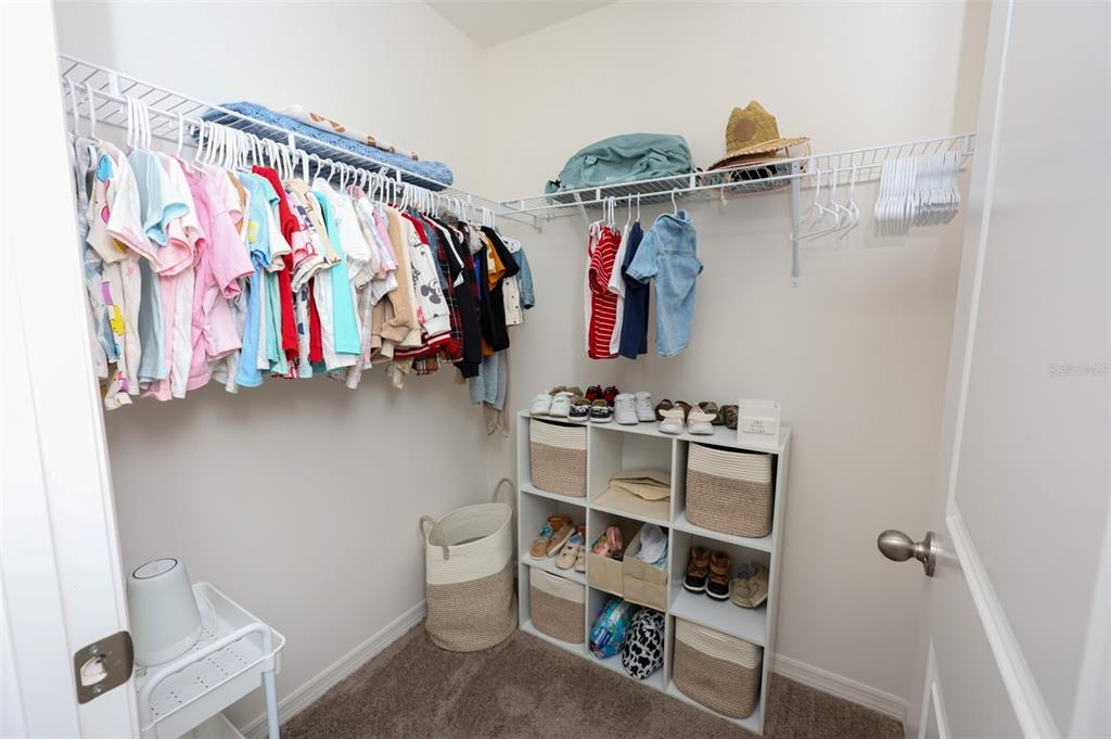1137 Bradford Rdg Drive Leesburg, FL 34748 - Photo 23 of 37 a view of walk in closet with clothes and shoes