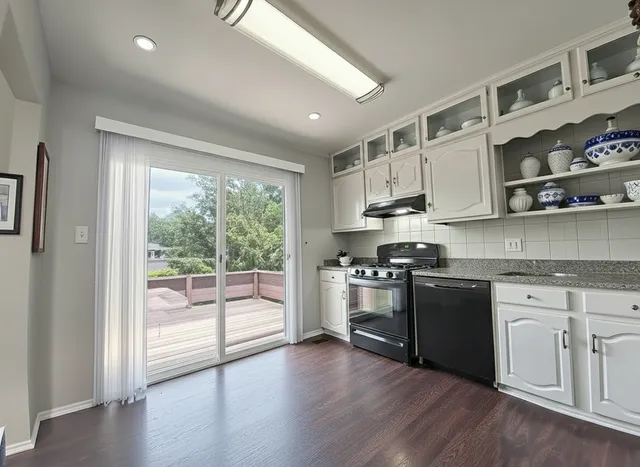 a kitchen with stainless steel appliances granite countertop a stove and a sink
