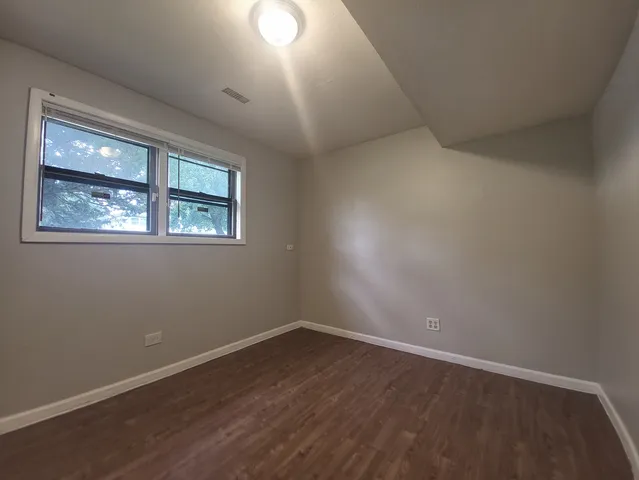 a view of room with wooden floor