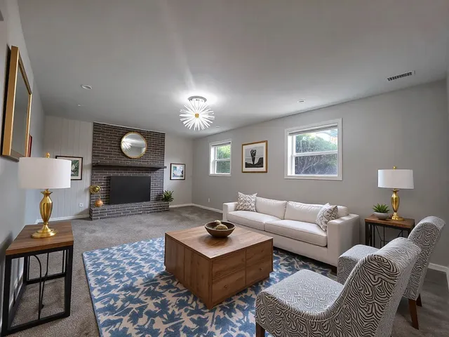 a living room with furniture and a fireplace