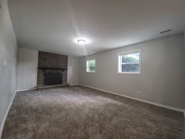 a view of empty room with a fireplace