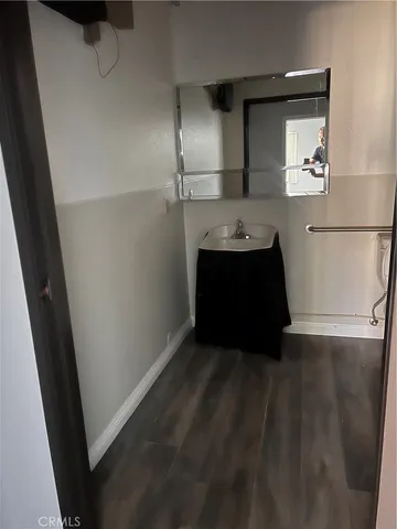 a living room with a sink and mirror
