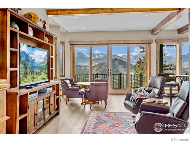 a living room with furniture tv and large window