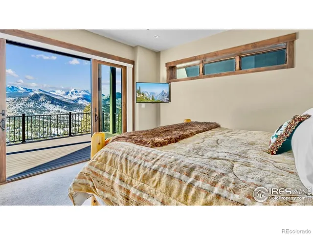 a bedroom with a bed and glass window