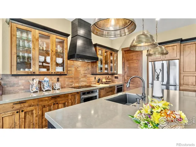 a kitchen with a stove a sink and a wooden cabinets
