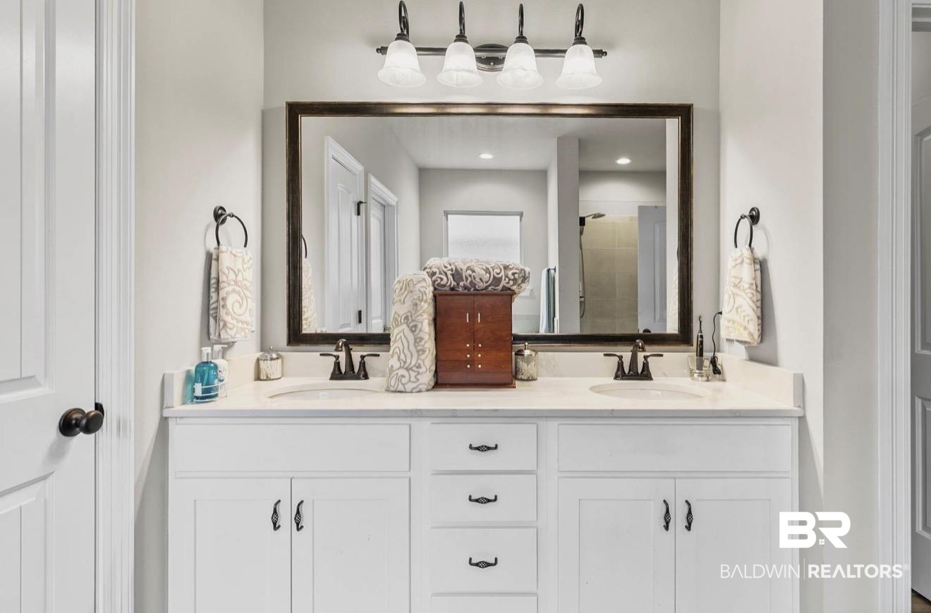 10126 Chipper Lane Foley, AL 36535 - Photo 16 of 30 Full bathroom with double vanity and a shower stall