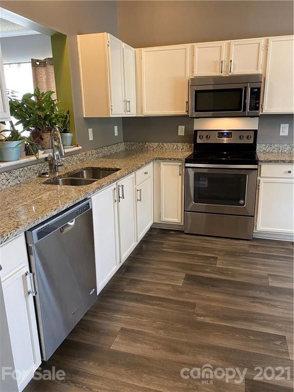 905 Lakehill Road Charlotte, NC 28214 - Photo 3 of 22 a kitchen with granite countertop a stove and a microwave
