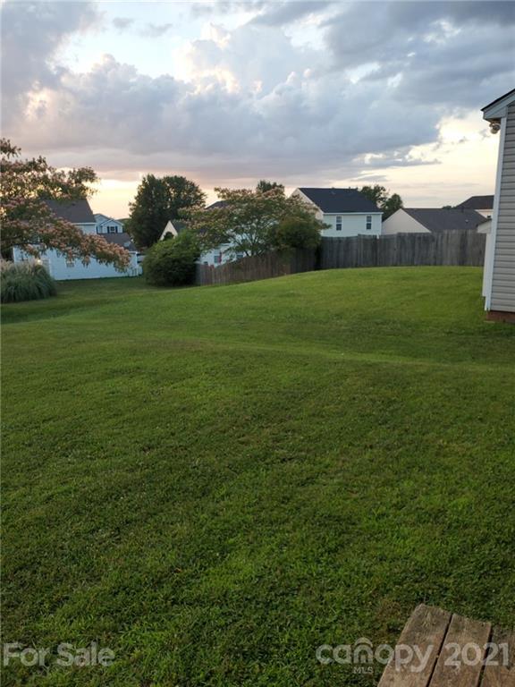 905 Lakehill Road Charlotte, NC 28214 - Photo 21 of 22 a view of a green field with house in the background