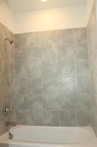 a bathroom with a shower and a sink