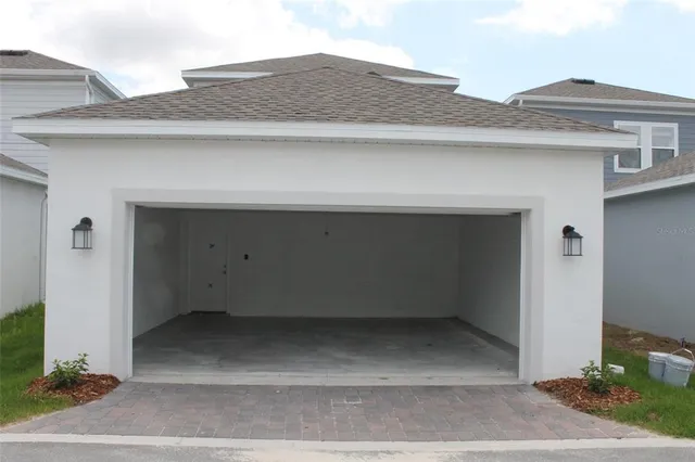 a view of a house with pool and chairs