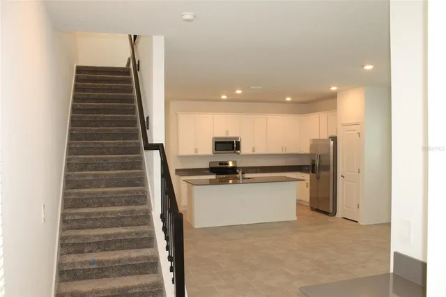 a kitchen with stainless steel appliances a refrigerator and a stove