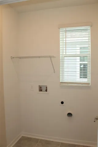 a bathroom with a window and a shower
