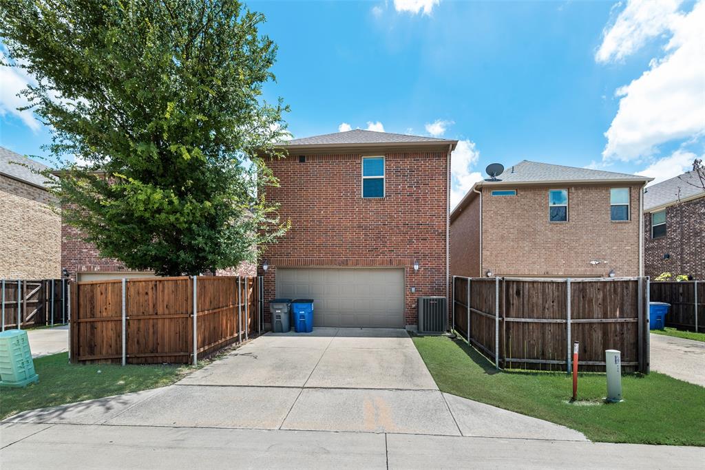 628 Ansley Way Allen, TX 75013 - Photo 20 of 20 Brick exterior featuring a two-car garage with an overhead door, concrete driveway, wood privacy fencing, and a mature tree
