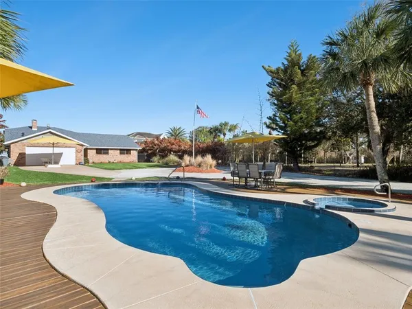 a view of swimming pool with sitting area and slide