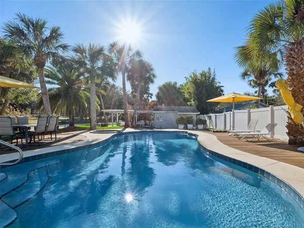 a view of a house with swimming pool and sitting area