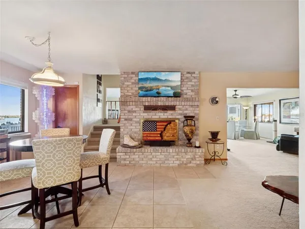 a kitchen with a sink and chairs