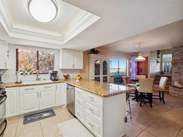 a kitchen with stainless steel appliances a table and chairs in it