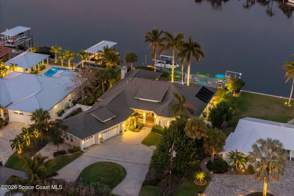 an aerial view of a house with a swimming pool