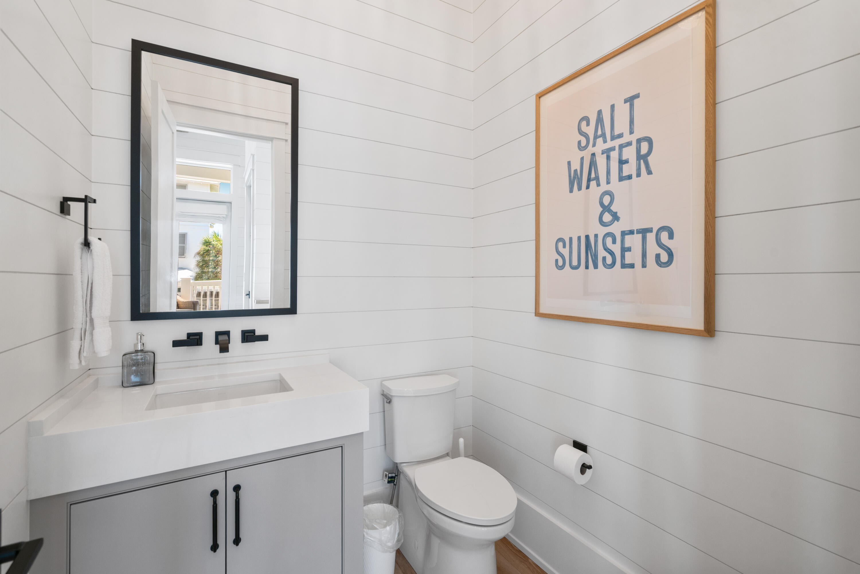 16 Bluewater View Ave Inlet Beach Inlet Beach, FL 32461 - Photo 32 of 59 a bathroom with a toilet sink vanity and mirror